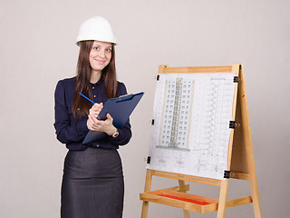 Image showing Architect girl writes theses folder