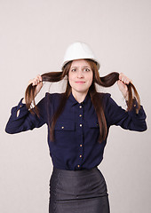 Image showing Young girl in shock clutching her hair