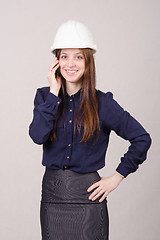 Image showing Beautiful girl in helmet talking on phone