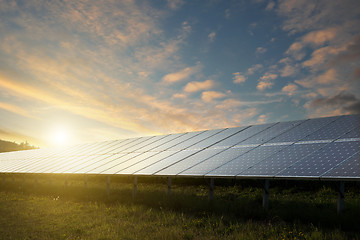 Image showing solar panels under sky on sunset
