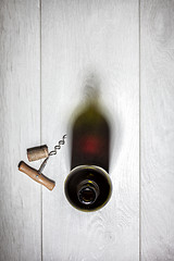 Image showing Bottle of red wine with cork on white wooden table