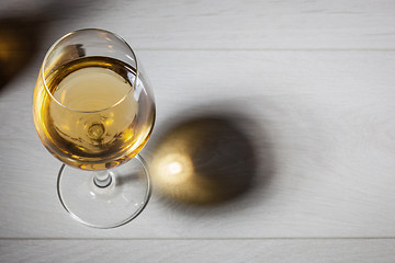 Image showing Glass of white wine on wooden table