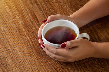 Image showing woman holding hot cup of tea