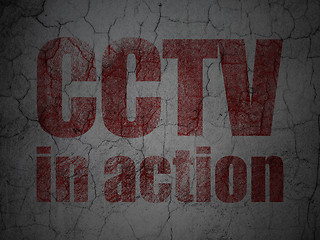 Image showing Protection concept: CCTV In action on grunge wall background