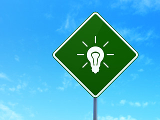 Image showing Finance concept: Light Bulb on road sign background