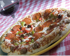 Image showing supreme pizza and red wine