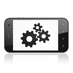Image showing Advertising concept: Gears on smartphone
