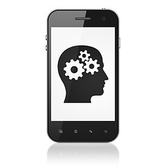 Image showing Advertising concept: Head With Gears on smartphone