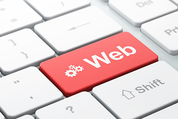 Image showing Web design concept: Gears and Web on computer keyboard backgroun