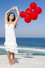 Image showing Beautiful girl holding red ballons