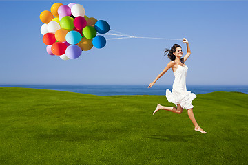 Image showing Jumping with a colored ballons