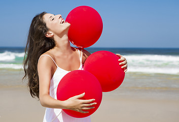 Image showing Beautiful girl holding red ballons