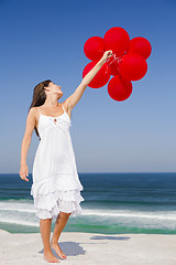 Image showing Beautiful girl holding red ballons