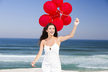 Image showing Beautiful girl holding red ballons