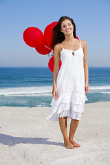 Image showing Beautiful girl holding red ballons