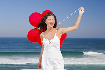 Image showing Beautiful girl holding red ballons