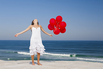 Image showing Beautiful girl holding red ballons