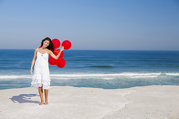 Image showing Beautiful girl holding red ballons