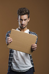 Image showing Young man holding a card board