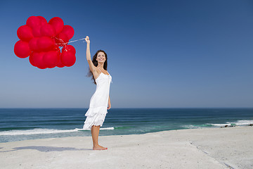 Image showing Beautiful girl holding red ballons