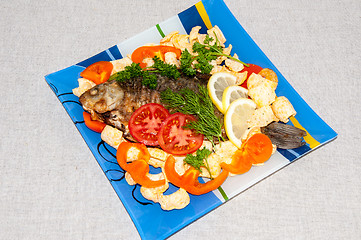 Image showing Fresh crucian river fish fried in lemon juice and fresh herbs.