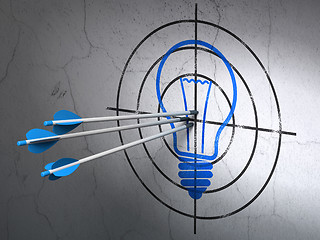 Image showing Business concept: arrows in Light Bulb target on wall background