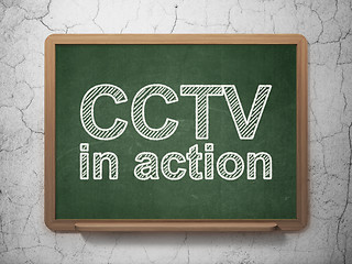 Image showing Privacy concept: CCTV In action on chalkboard background