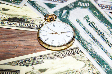 Image showing Pocket watches and money.