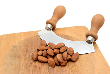 Image showing Whole almonds with a rocking knife