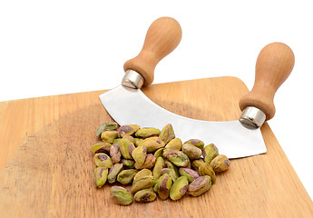 Image showing Whole pistachios with a rocking knife