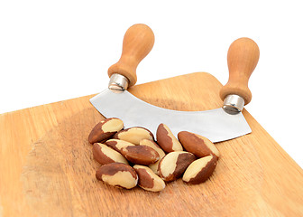 Image showing Whole brazil nuts with a rocking knife