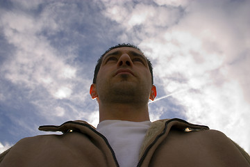 Image showing Man Looking up with the Clouds on the Background