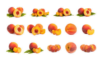 Image showing Set of tasty juicy peaches with slices on a white background