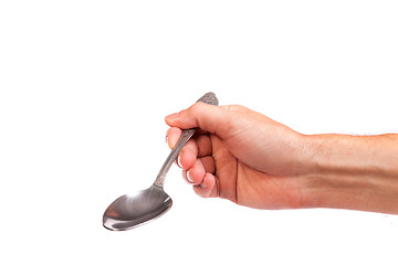 Image showing Hand is holding a spoon isolated