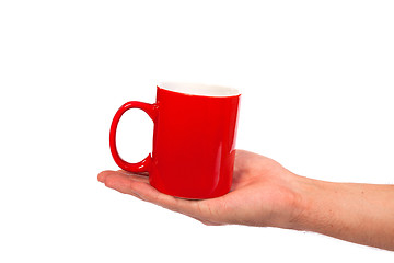 Image showing Male hand is holding a red cup