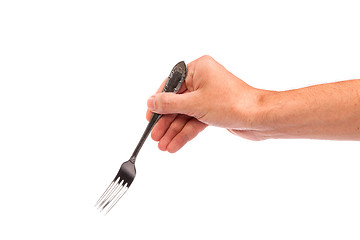 Image showing Right mans hand with empty metallic fork