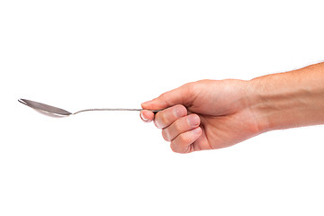 Image showing Hand is holding a spoon isolated