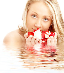 Image showing happy blond in water with red and white petals