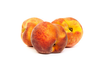 Image showing Three tasty juicy peaches on a white background