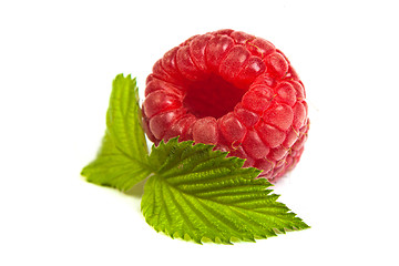 Image showing Ripe rasberry with green leaf isolated over white. Close up macr