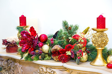 Image showing A fireplace mantle is decorated for Christmas with garland, ligh