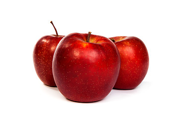 Image showing Three shiny red apples isolated on white