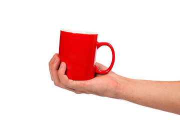 Image showing Male hand is holding a red cup
