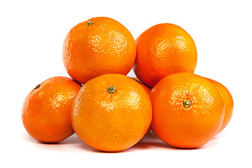 Image showing Group of ripe tangerine or mandarin with slices on white