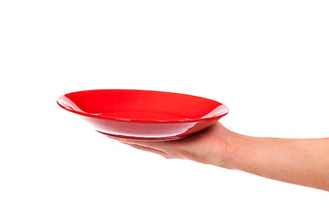 Image showing Red kitchen plate on a hand isolated