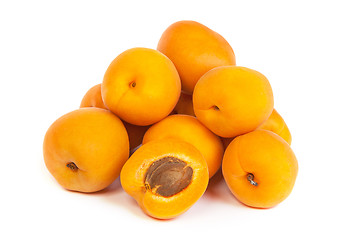 Image showing Group of ripe apricots with a half