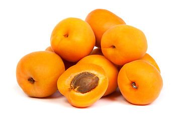 Image showing Group of ripe apricots with a half