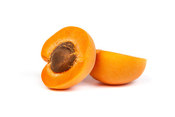 Image showing Two ripe apricot sectioned by knife