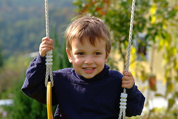 Image showing boy on the swing