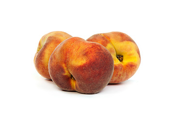 Image showing Three tasty juicy peaches on a white background